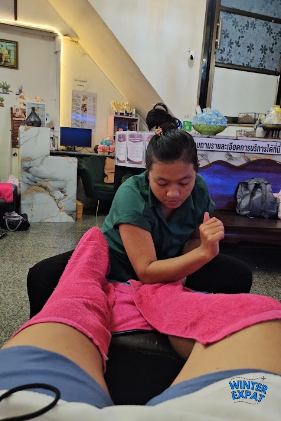 Ariana receives a foot massage from a therapist while relaxing inside Lek Massage in Bangkok's Samphanthawong district. Original photo by Ariana of WinterExpat.