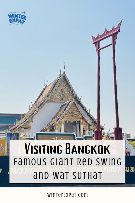 Wat Suthat and the Giant Red Swing in Bangkok with a travel guide title overlay in the foreground beneath a clear blue sky. Original photo by Ariana of WinterExpat.