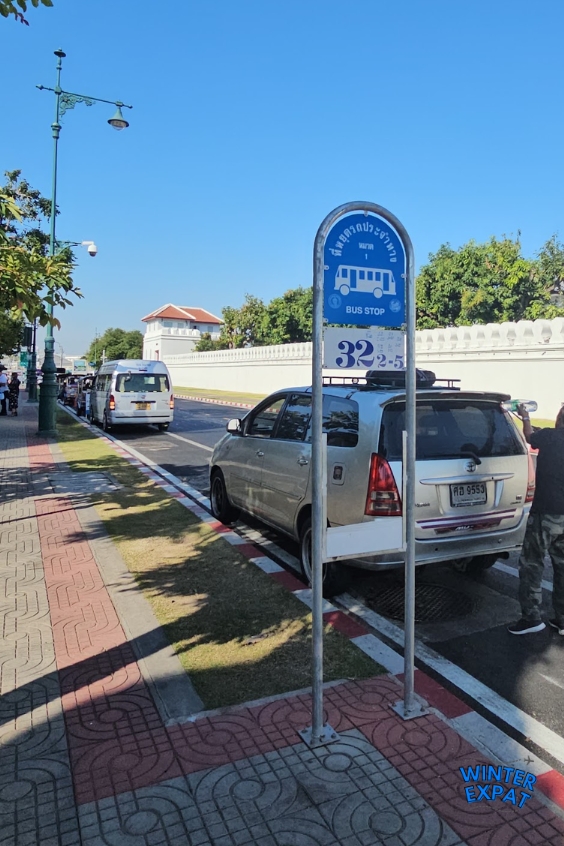 Public bus stop outside Wat Pho Temple in Bangkok with Route 32 sign, showing one of the public transport options for reaching the temple. Original photo by Ariana of WinterExpat.