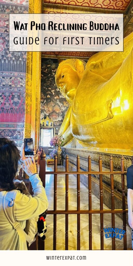 Close-up view of the massive golden Reclining Buddha at Wat Pho, showing the peaceful face, upper body, and detailed temple murals behind the statue. Original photo by Ariana of WinterExpat.